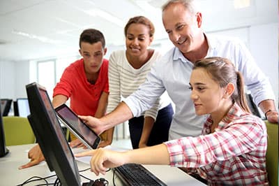 Group of people around a computer
