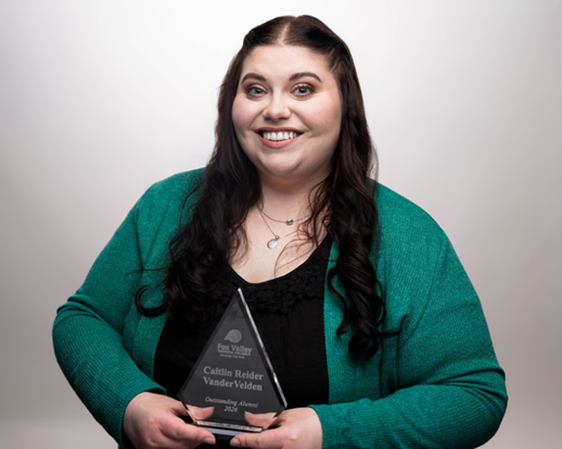 Caitlin Reider Vander Velden, the 2026 Outstanding Alumni, holding the Bryce Remy Outstanding Alumni Award