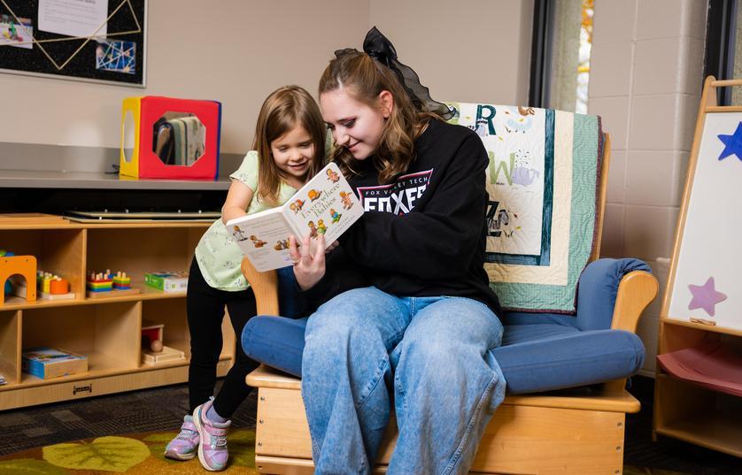 Teacher and child reading at the FVTC Child Care Center