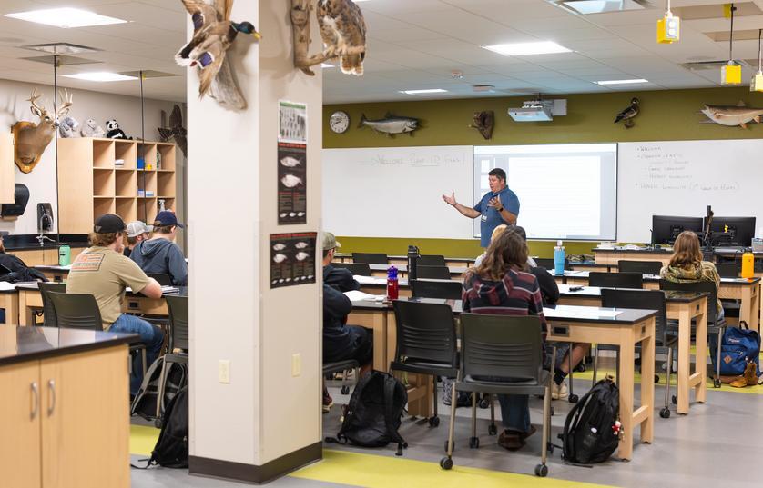 teacher lecturing classroom of students