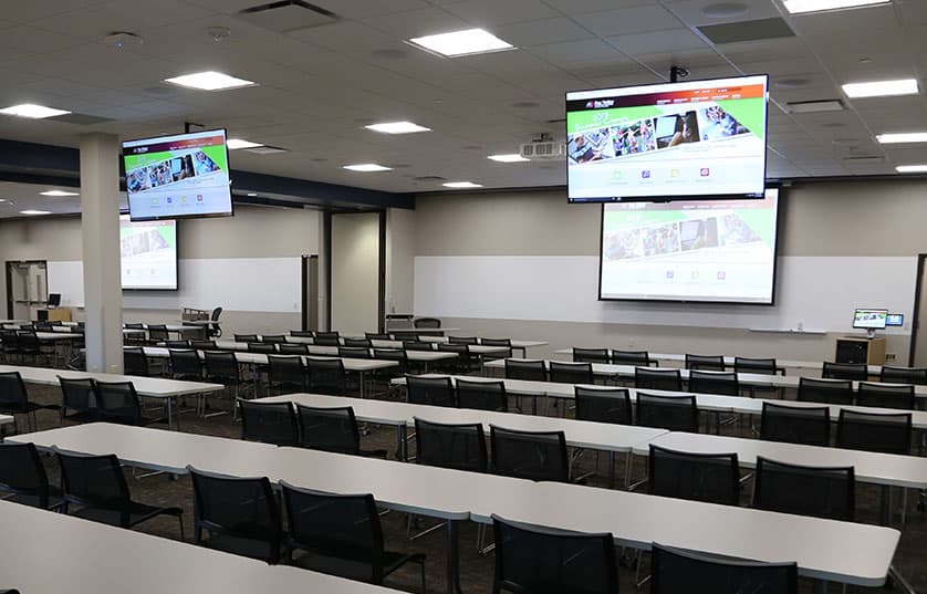 fvtc classroom with long tables and monitors hanging from ceiling