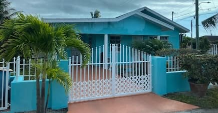 turquoise house with white gate