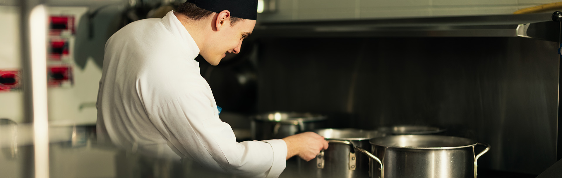 students learning culinary arts in kitchen classroom