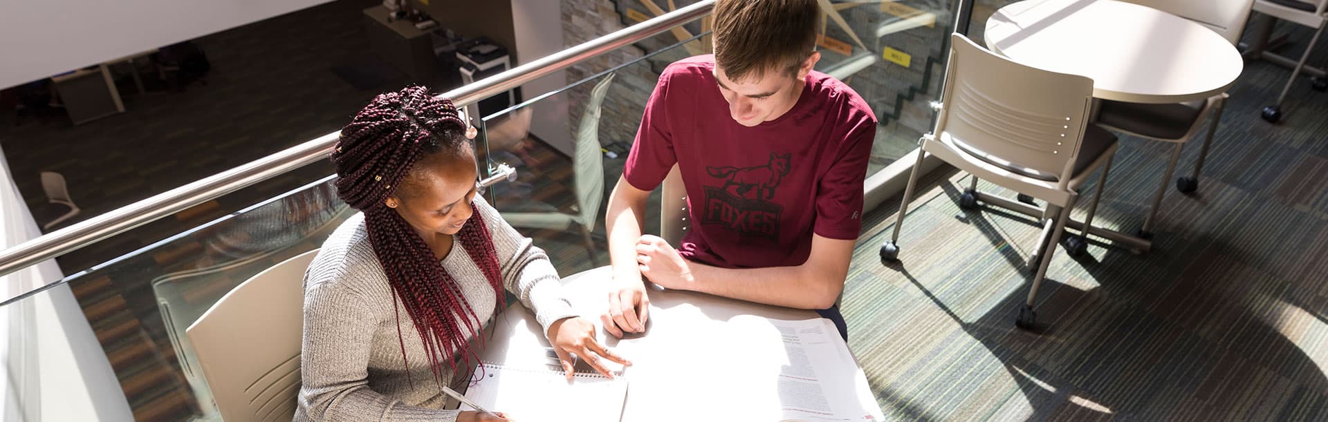two students studying at a table at Fox Valley Technical College